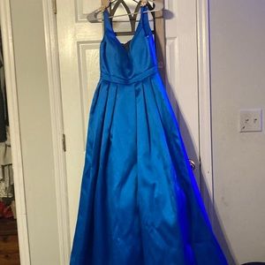 A beautiful long blue prom dress it has gold leaf pins on the straps